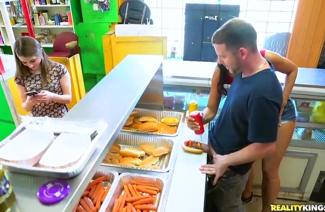 Sexy naked girl sucks and fucks a big wiener at the hot dog joint
