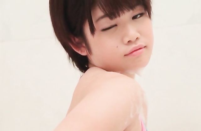 Nude Asian babe enjoys fingering the pussy under the shower