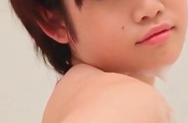 Nude Asian babe enjoys fingering the pussy under the shower