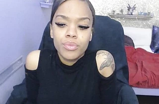 Stunning black teen sucks dildo before massaging naked sissy on cam