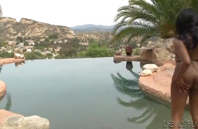 Weather is hot and naked girl with pierced black nipples relaxes by pool