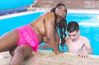 Ebony wench with naked breast strokes guy's cock with hand under water