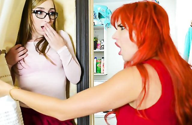 Girl with attractive look has naked leg of stepmother with red hair in pussy