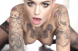 Bald tattooed slut girl with a tattooed body licks her lover's pecker and rides it rough