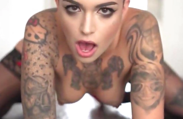 Bald tattooed slut girl with a tattooed body licks her lover's pecker and rides it rough