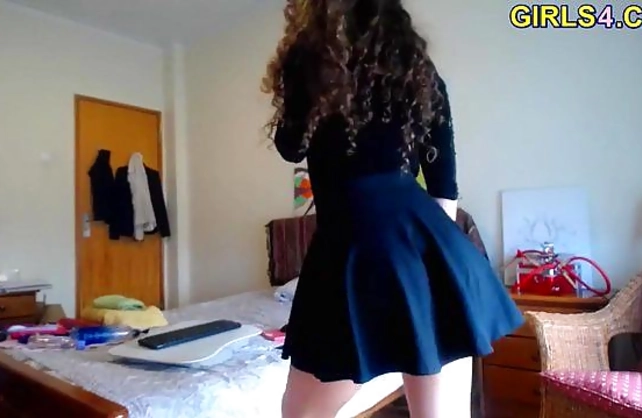 Curly-haired girl with naked legs seductively poses on web camera