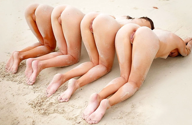 Four beautiful teen models enjoy being naked at the beach