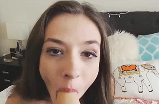 Attractive gal sucks dildo and gently thrusts it into her naked peach