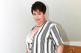 Mature lady with naked body wears stockings and masturbates pussy