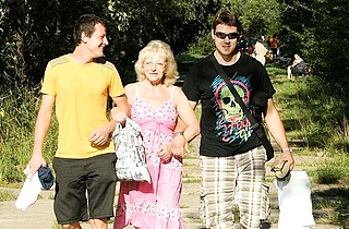Young guys pick up an old woman and have naked sex in the forest