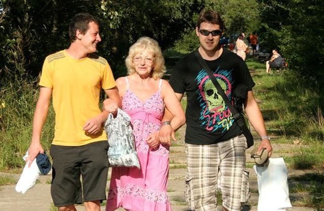 Young guys pick up an old woman and have naked sex in the forest