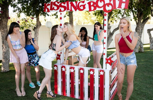 Blonde lesbian is fucking a redhead diving deep in her butthole with her tongue at the Kissing Booth