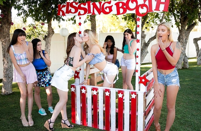 Blonde lesbian is fucking a redhead diving deep in her butthole with her tongue at the Kissing Booth