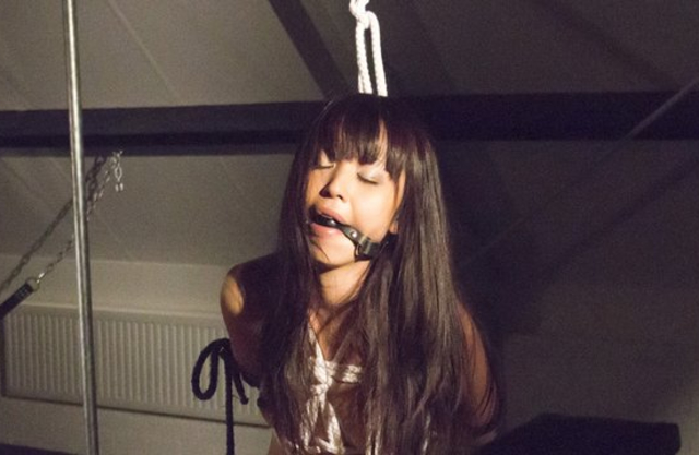 Gagged Asian girl sucks dick naked on the knees after being dominated