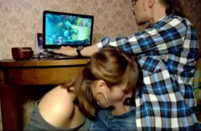 Guy plays Dota but a hot naked girl takes his erect cock in her mouth