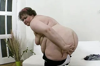 Sexy naked girl with humongous charms tries to reach and masturbate twat