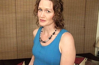 Naked girl talks to the cameraman and takes her sexy blue dress off