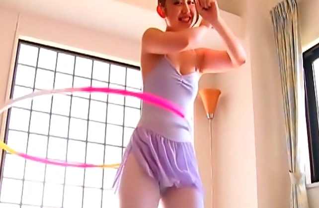Inviting oriental not naked girl looks pretty sexy rolling a hoop