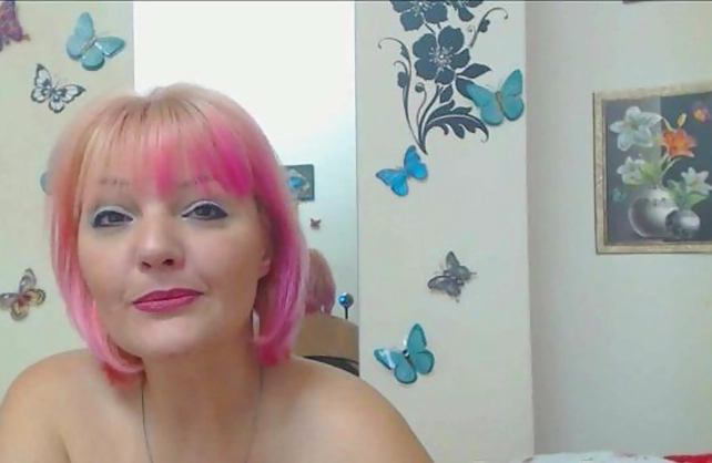 Naked girl over forty with pink hair performs a sexy webcam show