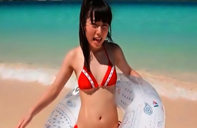 Winsome Japanese girl wears red swimsuit instead of being naked