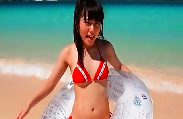 Winsome Japanese girl wears red swimsuit instead of being naked
