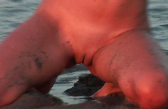 Adult model with beautiful naked body willingly poses by water