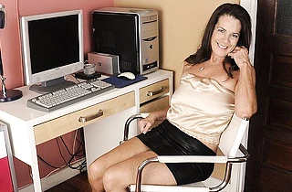 Horny granny is talking on the phone naked while fingering her hole