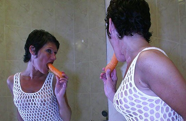 A carrot is what the naughty naked woman has to use on her wet cunt