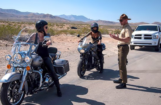 Police officer stops two naked inked chicks before having a threesome