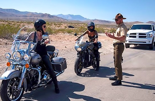 Police officer stops two naked inked chicks before having a threesome