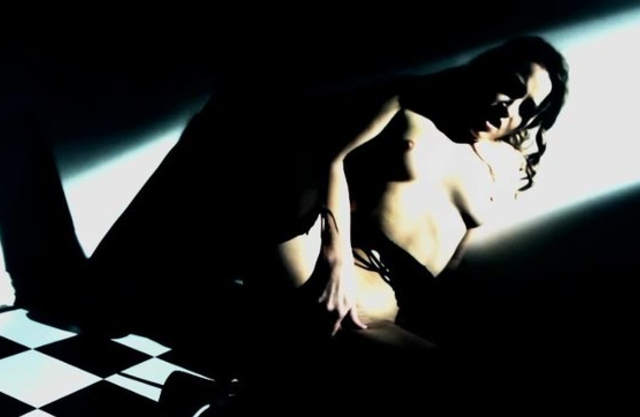 Sensuous housemaid in stockings stimulates naked pussy in the dark
