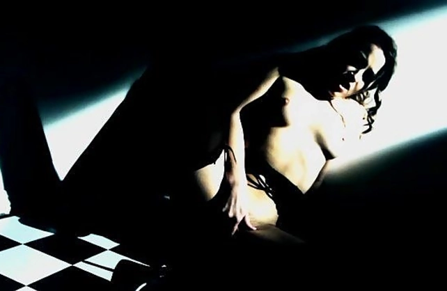 Sensuous housemaid in stockings stimulates naked pussy in the dark
