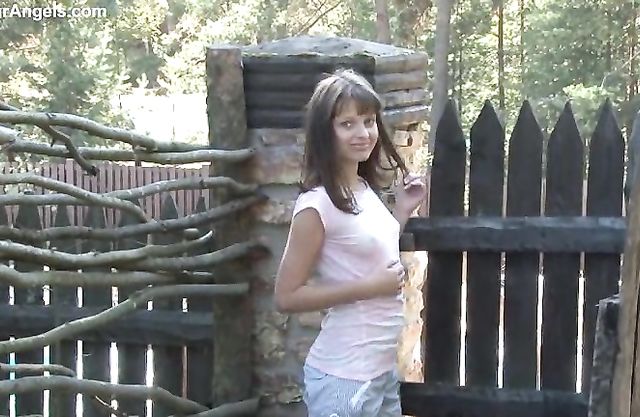 Small-tittied naked girl poses naked in the woods enjoying herself in this erotic scene