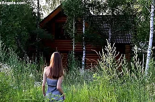 Naked teen girl walks around in the countryside demonstrating her lean body and hairy kitty
