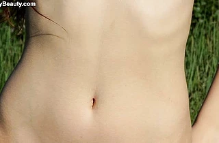 Naked redhead girl with small tits enjoys playing a naughty solo near the water