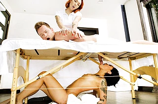 Hot and horny naked girl sucks this guy`s dick under the massage table