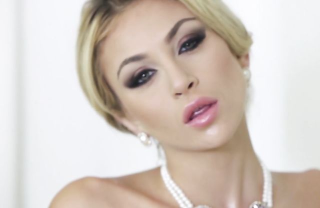 Glamour blonde with big fake tits poses on cam showing off her amazing body