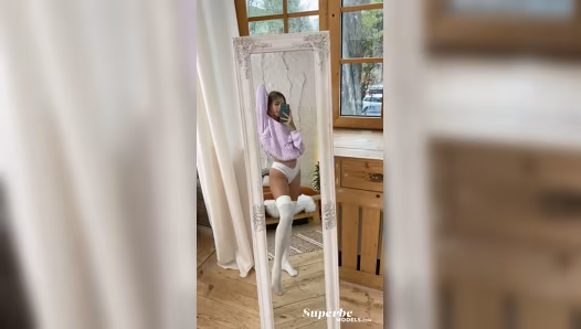 Model poses naked in stockings while filming herself