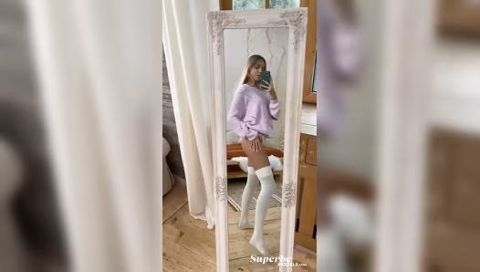 Model poses naked in stockings while filming herself