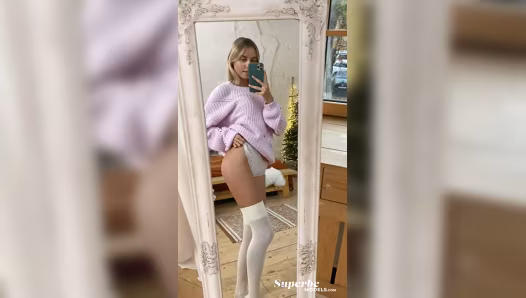 Model poses naked in stockings while filming herself