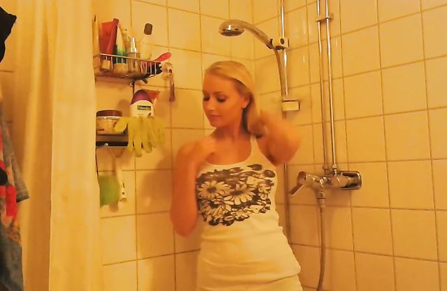 Appealing nude blonde flashes tits in the shower while on cam
