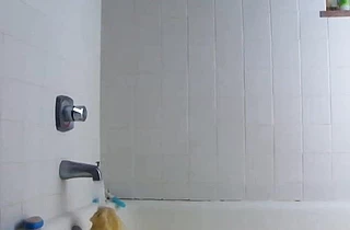 Innocent looking young girl takes a ride on a dildo dong in the shower