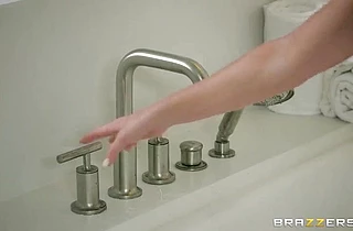Fascinating woman with fake tits masturbates in a bath and moans loudly