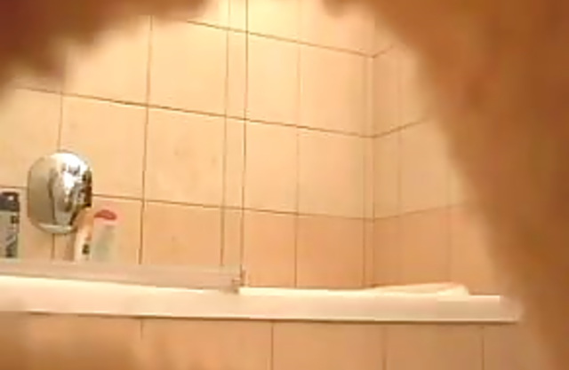 Sexy looking honey takes off her thong to get naked before taking a shower