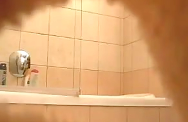 Sexy looking honey takes off her thong to get naked before taking a shower