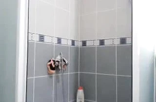 Naked babe with a good body takes off her bikini nicely in the shower