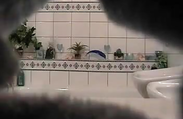 Very sexy naked babe strokes her adorable body in the shower on a hidden cam
