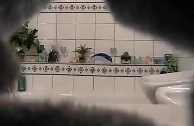 Very sexy naked babe strokes her adorable body in the shower on a hidden cam