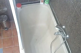 Naked slut goes wild on her shaved pussy while alone in the shower