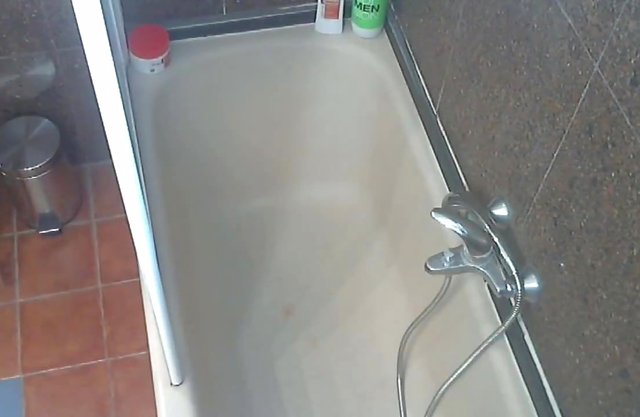 Busty nude female caught on cam when showering and fingering her twat